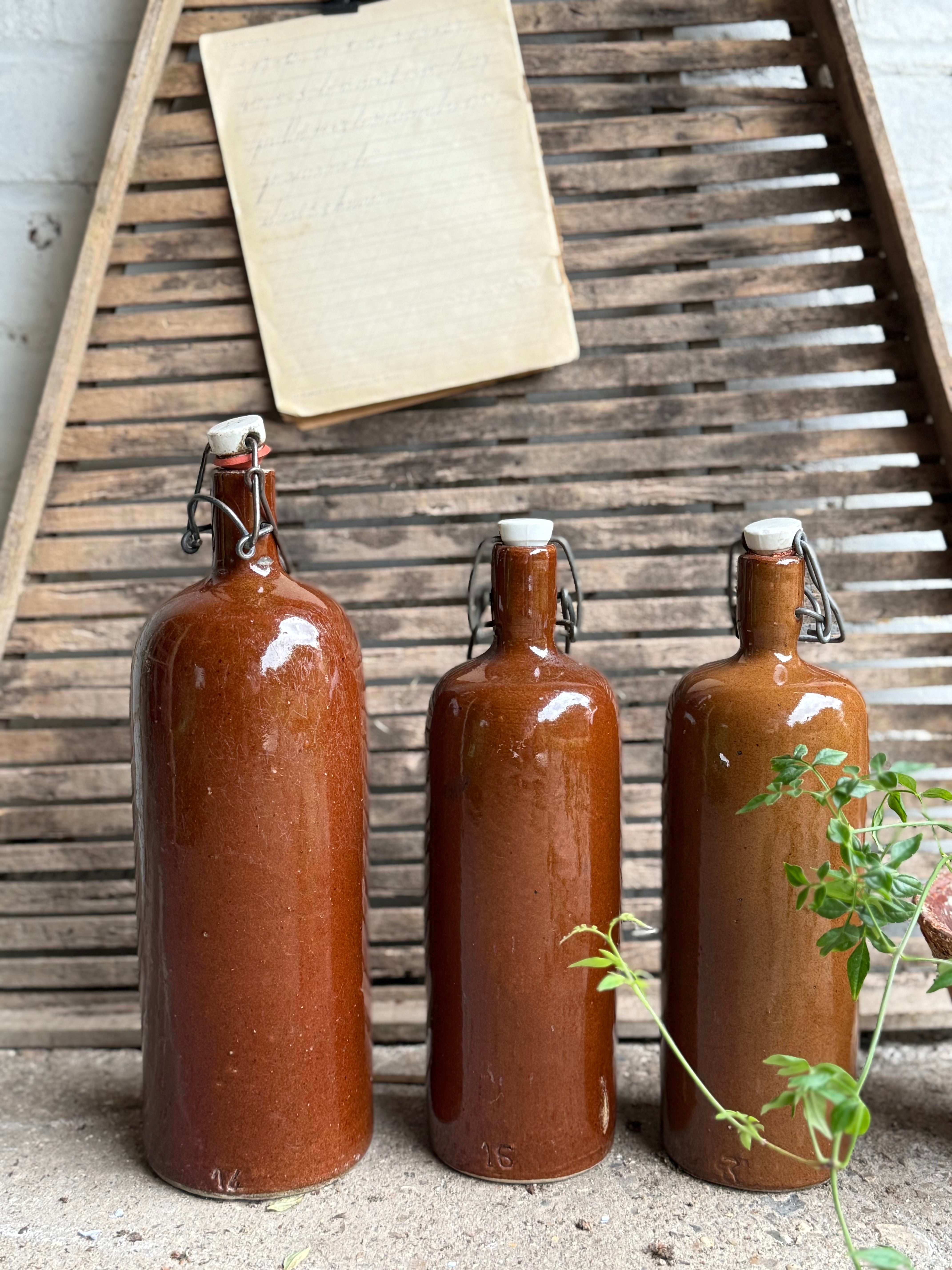 Trio of Stoneware Soda Bottles with Porcelain Swing Stoppers