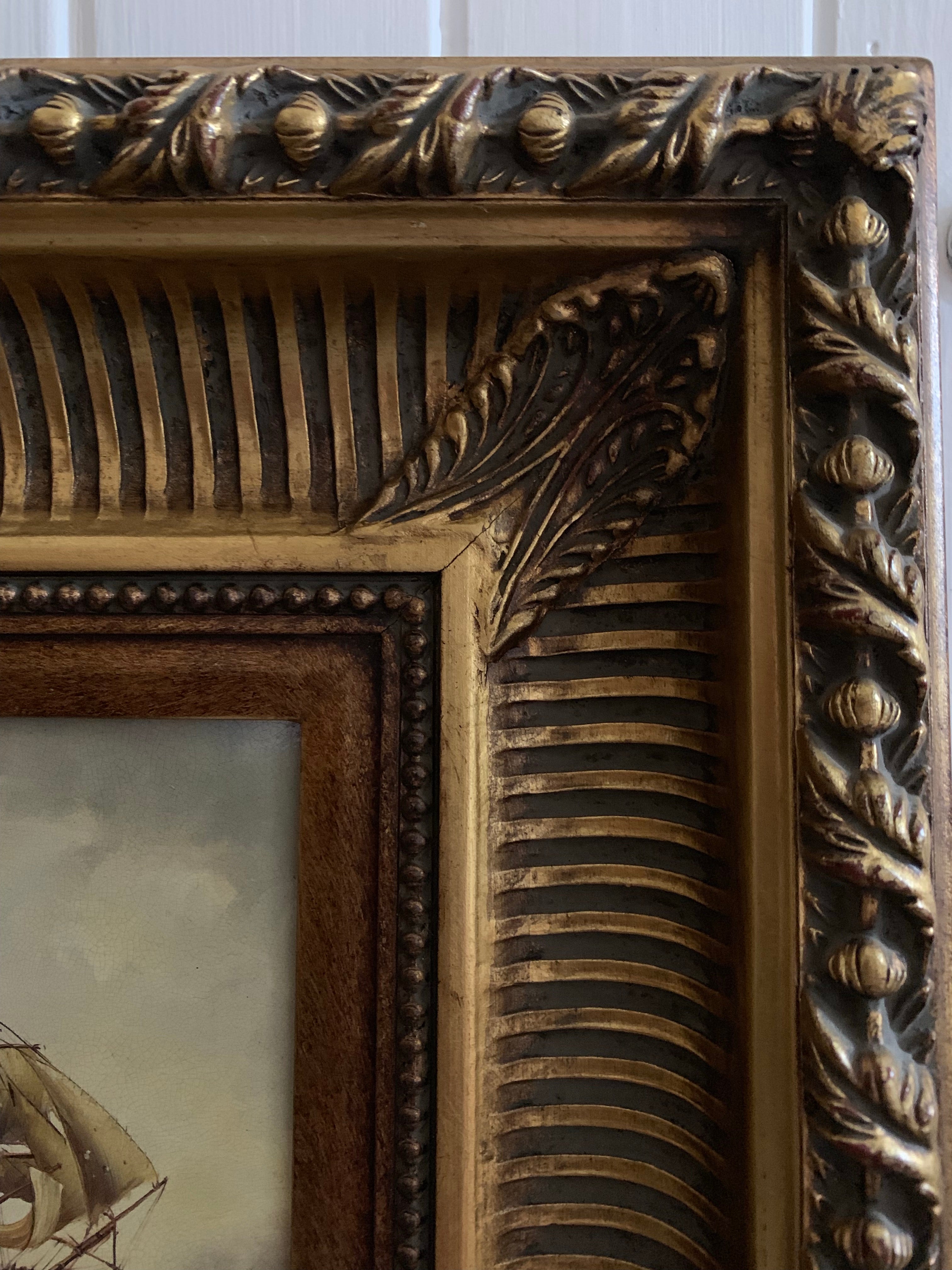 Pair of carved gilt frames with prints depicting 18th century ships