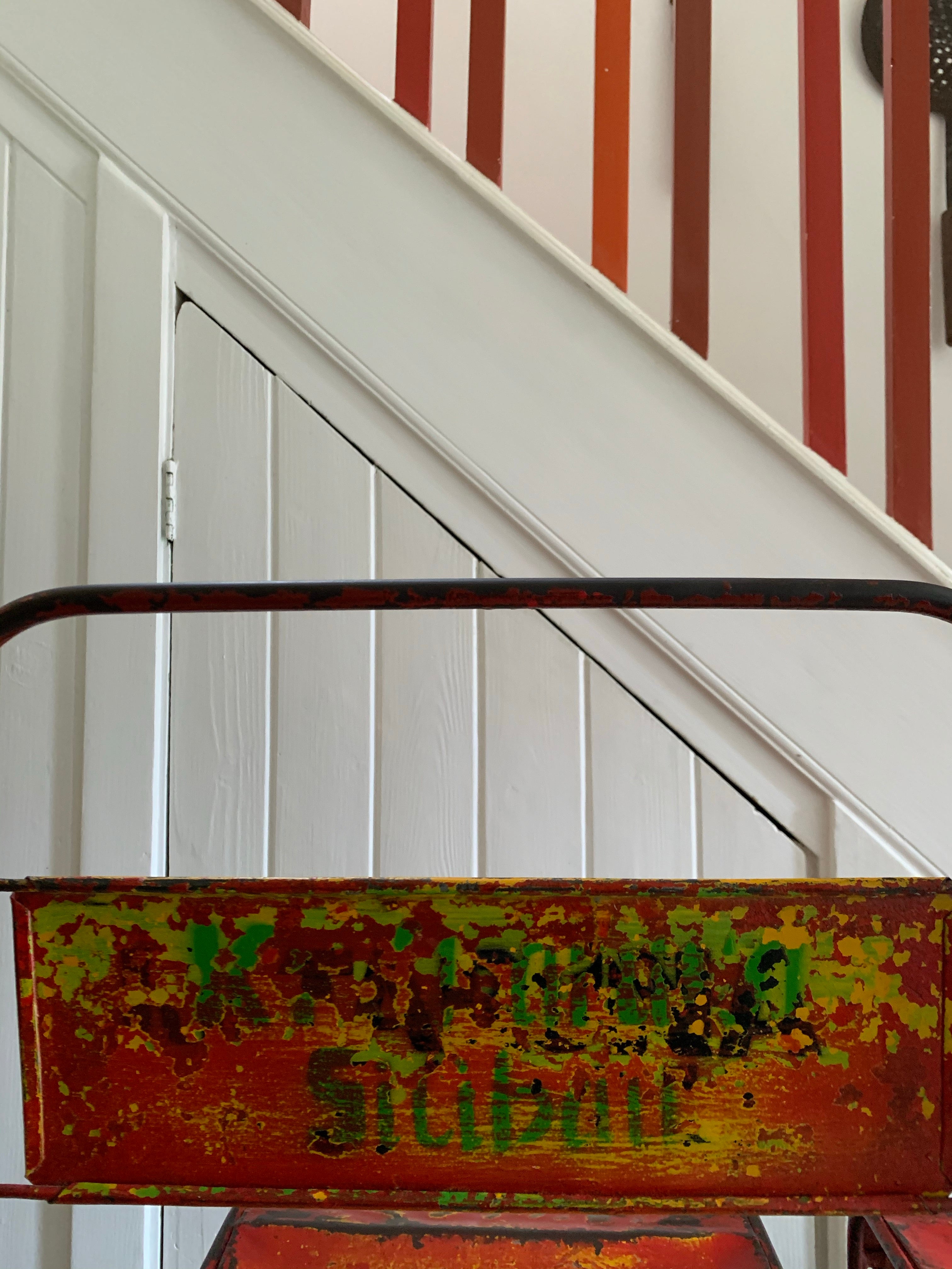 Pair of red/orange metal stacking chairs