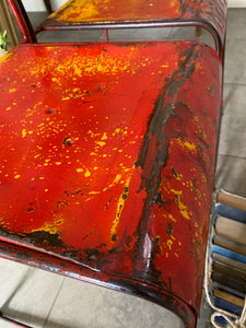 Pair of red/orange metal stacking chairs
